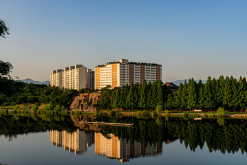 Fototapeta na wymiar Riverside Apartments Building Shape Reflect On The River