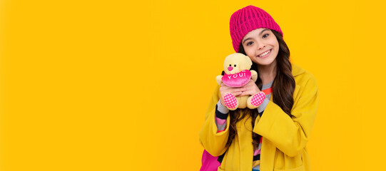 Winter school. Funny school girl with toy. Happy childhood and kids education. Banner of child girl with toy, studio portrait, header with copy space.
