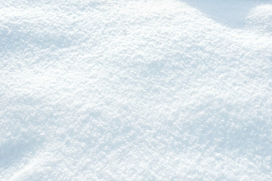Beautiful background image of winter nature - texture pure fluffy fresh snow with a bluish tint.