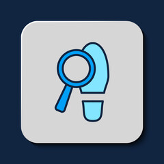 Filled outline Magnifying glass with footsteps icon isolated on blue background. Detective is investigating. To follow in the footsteps. Vector