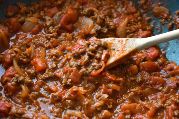 Bolognese sauce in a saucepan.  Spaghetti Bolognese cooking preparation concept. Traditional Italian food.