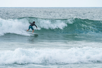 Local surfer riding waves