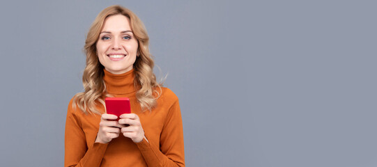 Happy woman chat messages online on smartphone mobile communication grey background, chatting. Woman portrait, isolated header banner with copy space.