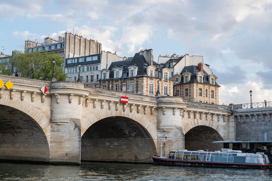 Famous Pont Neuf is the oldest standing bridge across river Seine in Paris, France with grotesk heads representing forest and field divinities from ancient mythology.