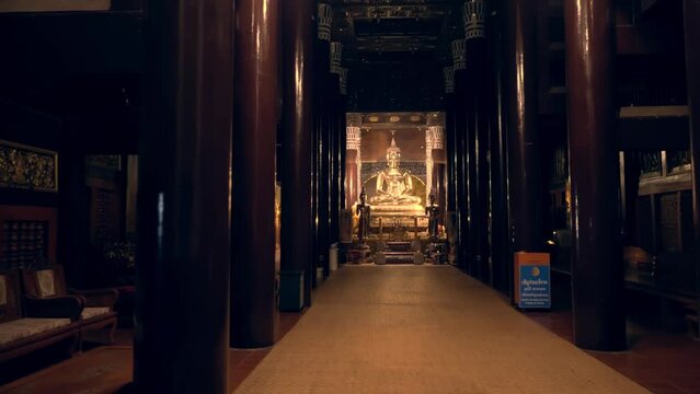 Dark interior of column hall of the Thai temple