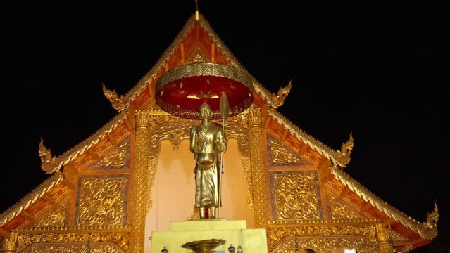Thai temple at the night. Camera zoom on sculpture