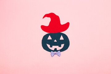dark blue paper pumpkin with hat ready for party, creative art halloween concept, flat lay paper craft