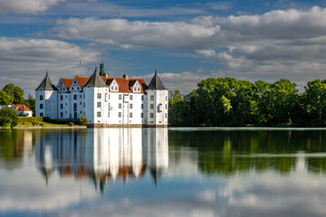Fototapeta na wymiar Gluecksburg Castle on the Flensburg Fjord photographed from the lake side.