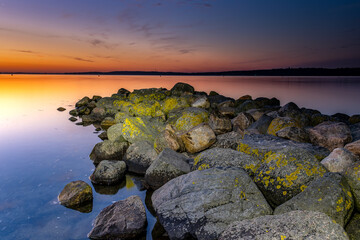Sunrise at the Baltic Sea. Stone mole leads into the sea. Harrislee, Baltic Sea, Fjord, Flensburg,...