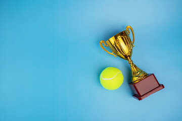 tennis cup, golden prize, winner award, ball and goblet on a blue background