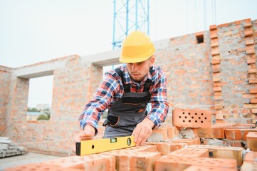 Construction worker in uniform and safety equipment have job on building