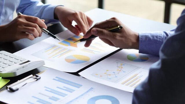 Meeting business people are analyzing business finance and investment charts and discussing the company's marketing growth strategy. Accounting and Financial Planning