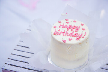 white small cake with inscription happy birthday