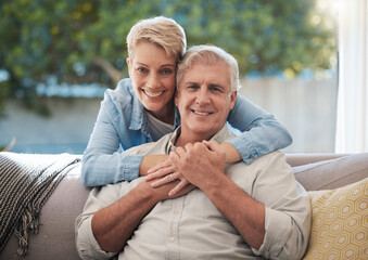 Couple, love and senior man and woman sitting on a sofa in the living room and enjoying retirement....