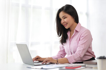 Financial business woman working with laptop in home office.