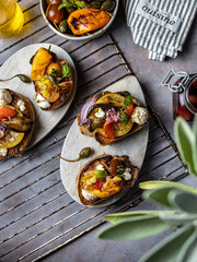 Fresh bruschetta with tomato ,olive oil ,garlic,paprika,capers and basil and with grilled eggplant.
