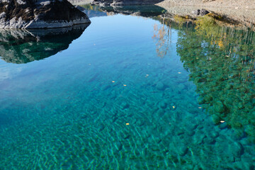 Turquoise clear water in a mountain lake. Autumn Altai.