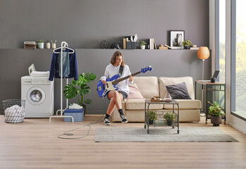 Teenage girl playing a guitar in the grey wall room concept, washing and dry machine, sofa and...