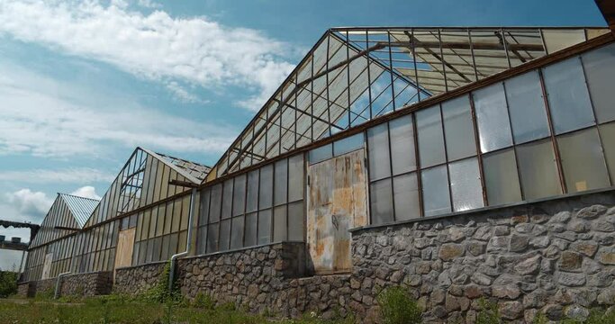 Abandoned greenhouses with broken glasses