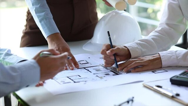 Architects and engineers are working together to edit the draft house plan that was designed after it was presented to the client and partially revised the design. Interior design and decoration ideas