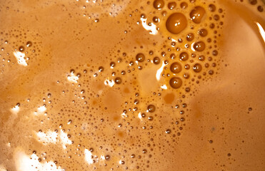 Coffee milk foam. Background texture of cappuccino, closeup. Macro.