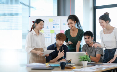 Fototapeta premium Group of asian business meeting and discussing with new startup idea project. Creative business people planning strategy analysis and brainstorm with document report in office