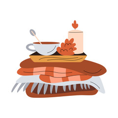Cute composition with a cup of warm drink, cone, candle and knitted wool clothes or blankets