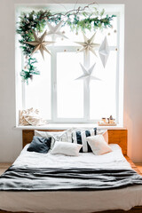 Bed near window christmas bedroom interior
