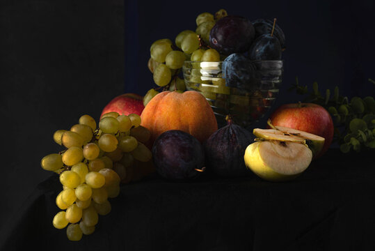 Blurred image of a still life with fruit on a dark background in the Dutch style.