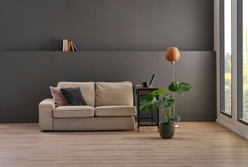 Grey wall background, armchair and orange lamp decoration with vase of plant style.