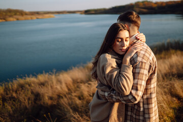 Happy couple in love walking in the park on a autumn day. Relaxation, youth, love, lifestyle concept.