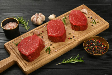 Close up raw beef tenderloin steak on board
