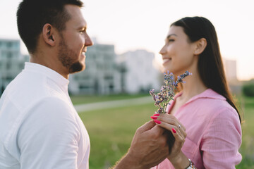 Boyfriend gifting pollen flowers to girlfriend during date