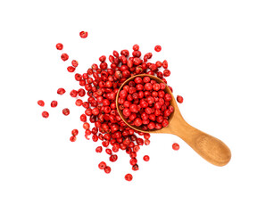 Wooden scoop spoon full of pink peppercorns