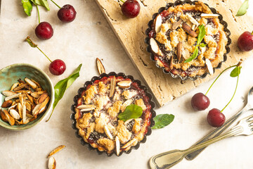 Mini tart with cherries on a grey background