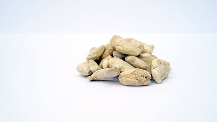 Fototapeta na wymiar Heap of dried ginger roots on white background. Dried Organic Ginger or Dry Adrak also known as Sonth in India