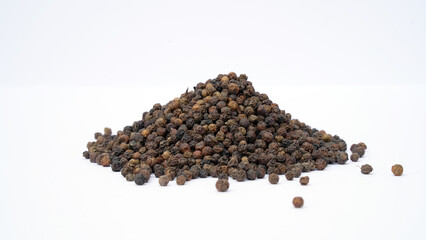 Pile of Organic Black pepper (Piper nigrum) isolated on white background. milled black pepper ,Black pepper corns. Black pepper grains as background close up