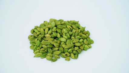 Cardamom pods and seeds isolated on white background. Green cardamom pods isolated on white background with copy space for text or images. Spices, food, cooking concept. Close-up shot.