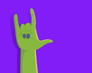 Zombie hand making rock gesture on purple background with right side copyspace. Person with green make up disguise for Halloween party