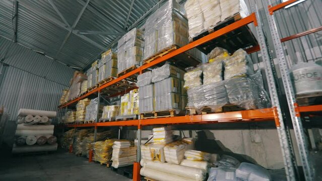 Warehouse with rolls of nonwovens. Large warehouse in a nonwoven fabric factory. Large roll of spunbond