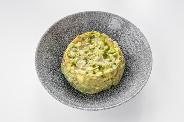 Guacamole served in a dish isolated on grey background top view