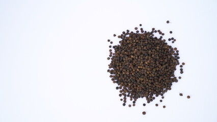 Pile of Organic Black pepper (Piper nigrum) isolated on white background. milled black pepper ,Black pepper corns. Black pepper grains as background close up
