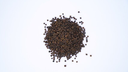 Pile of Organic Black pepper (Piper nigrum) isolated on white background. milled black pepper ,Black pepper corns. Black pepper grains as background close up