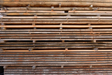 wood boards piled up in the warehouse of a carpentry