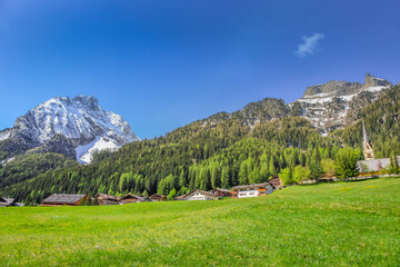 Fototapeta na wymiar Village near Cortina D Ampezzo and alpine meadows with Dolomites alps, Italy