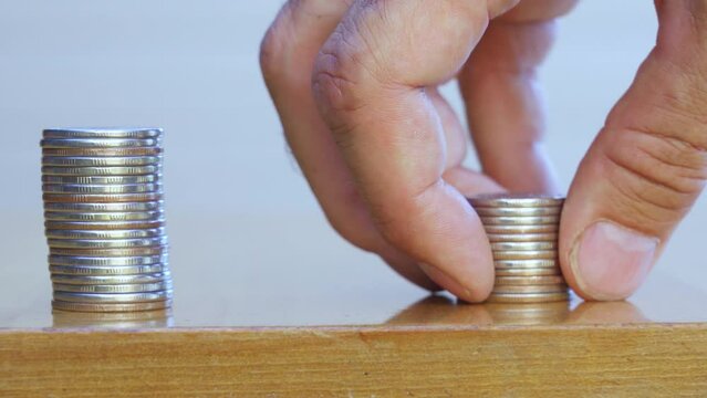 Man's hand put money coins to stack of coins. Money, Financial, Business Growth concept.