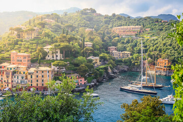 Fototapeta na wymiar Above Portofino with houses, luxury boats and yacht, bay harbor. Liguria, Italy