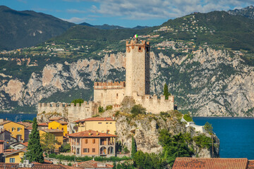 Fototapeta na wymiar Idyllic Lake Garda above Malcesine old town with Italian flag and mountain range