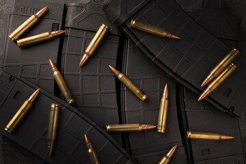 Cartridges for a rifle lying on Ar15 magazines.