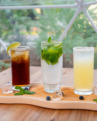 cocktail tray with lime and mint garnishes
